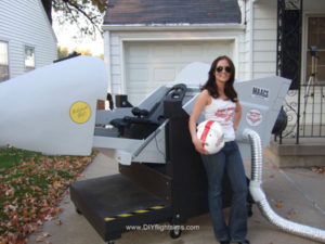 woman standing in front of a large flight simulator